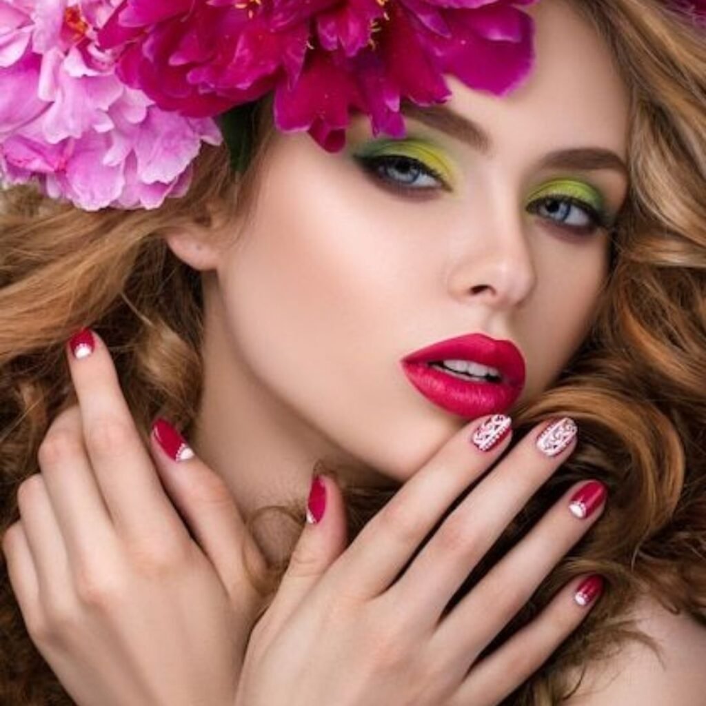 A model with vibrant makeup and floral accents highlights artistic beauty techniques.